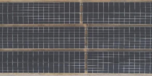 Aerial shot of Solar power energy panels installed on the ground at the Emicool site in Dubai, UAE.

